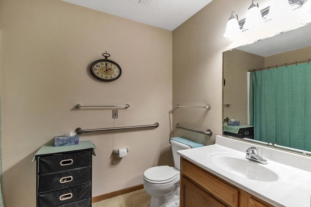 a bathroom with a sink toilet and a mirror