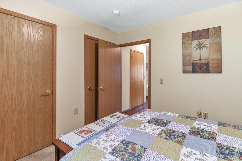 a bedroom with a bed and a closet