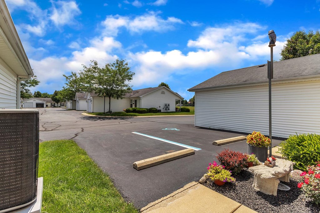 an empty parking lot in front of a house