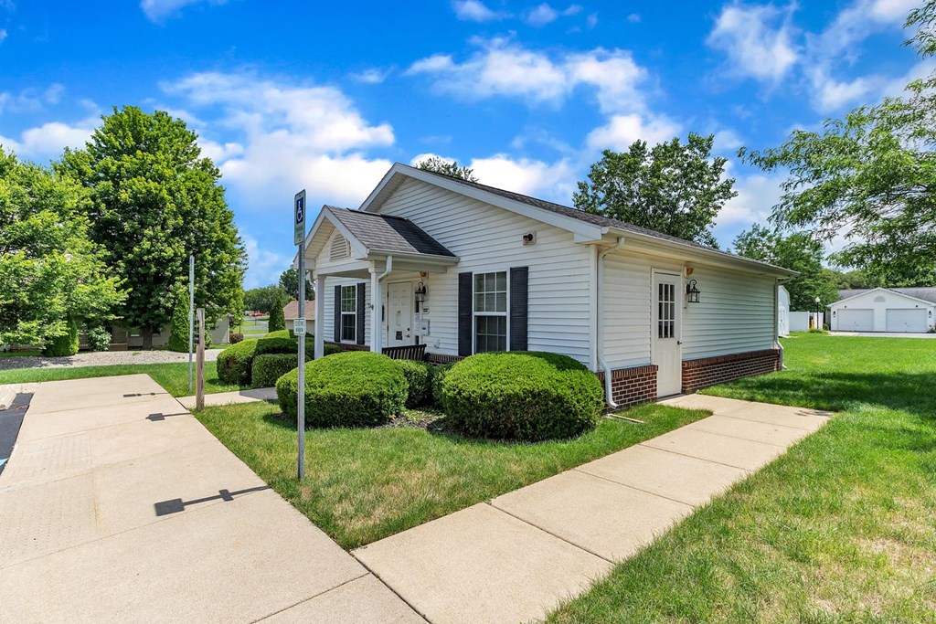 a white house with a sidewalk in front of it