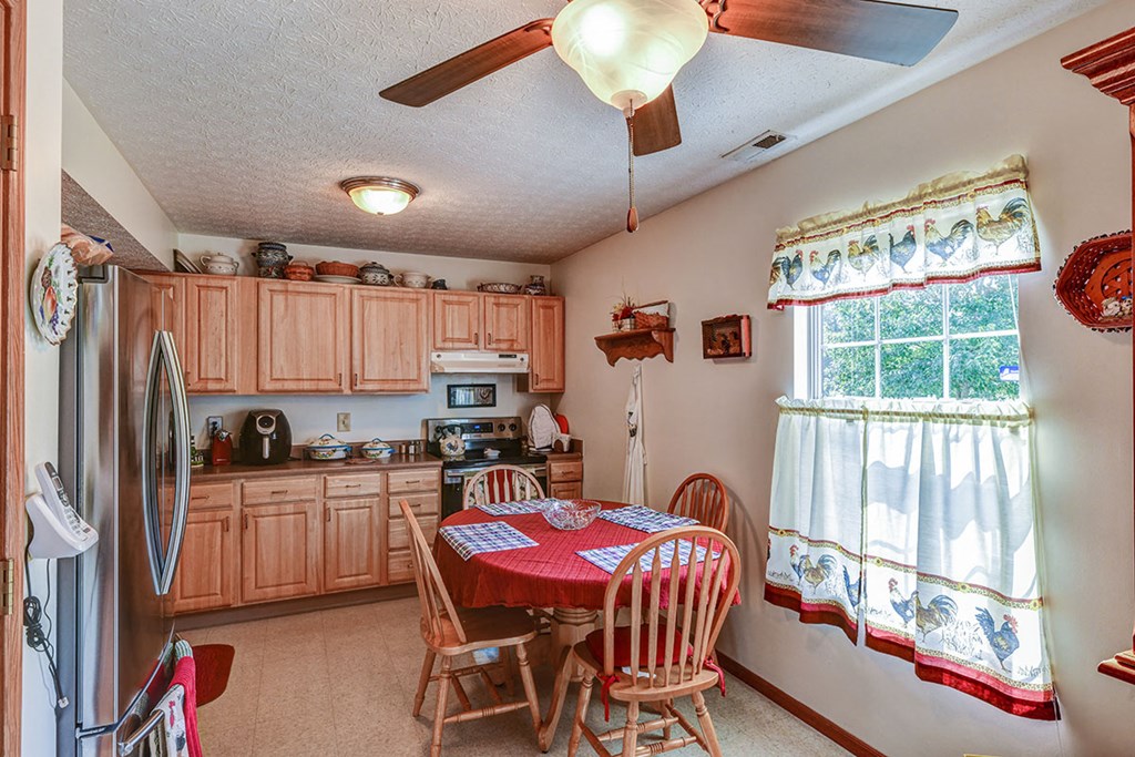 a kitchen with a dining table and a refrigerator