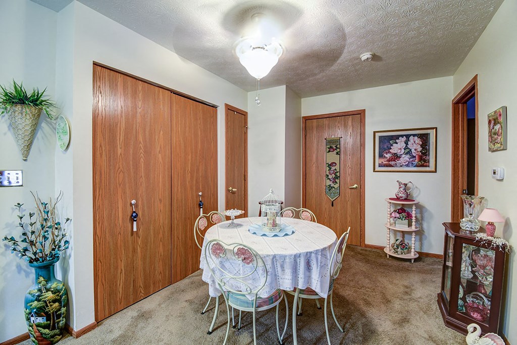 a dining room with a table and chairs