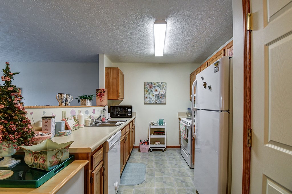 a kitchen with a christmas tree and a white refrigerator
