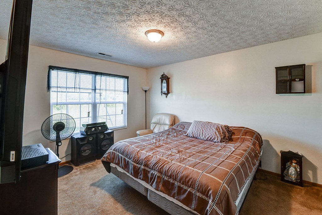 a bedroom with a bed and a window