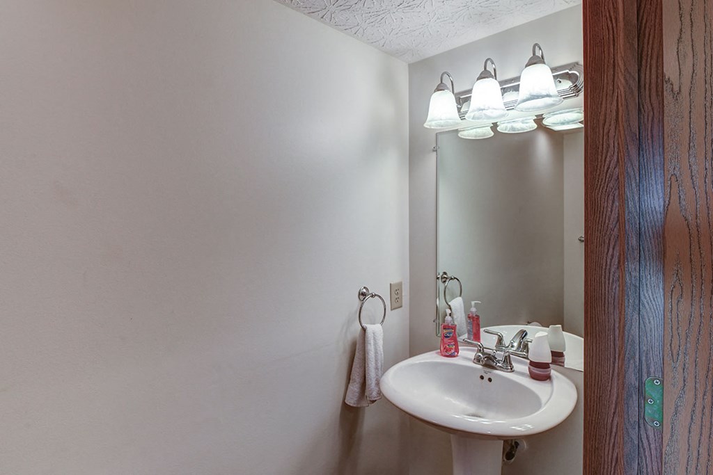 a bathroom with a white sink and a mirror