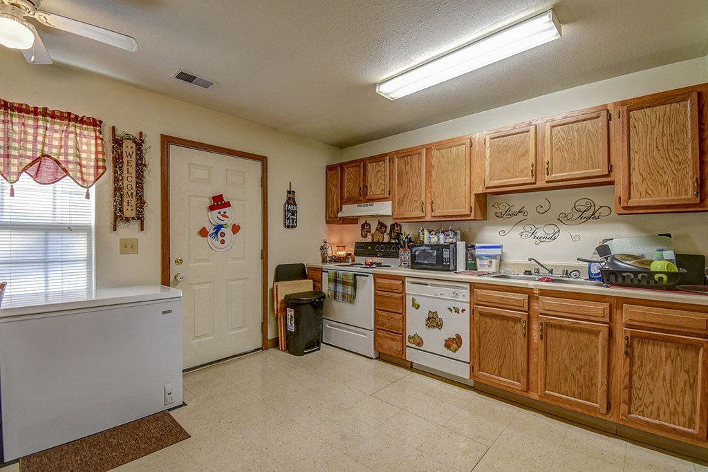 a kitchen with wooden cabinets and a white refrigerator
