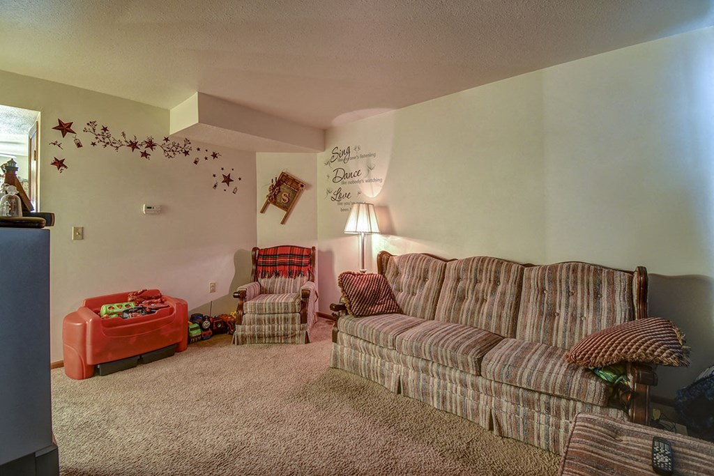 a living room with a couch and two chairs
