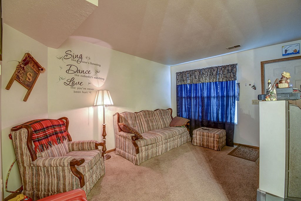 a living room with two couches and a window