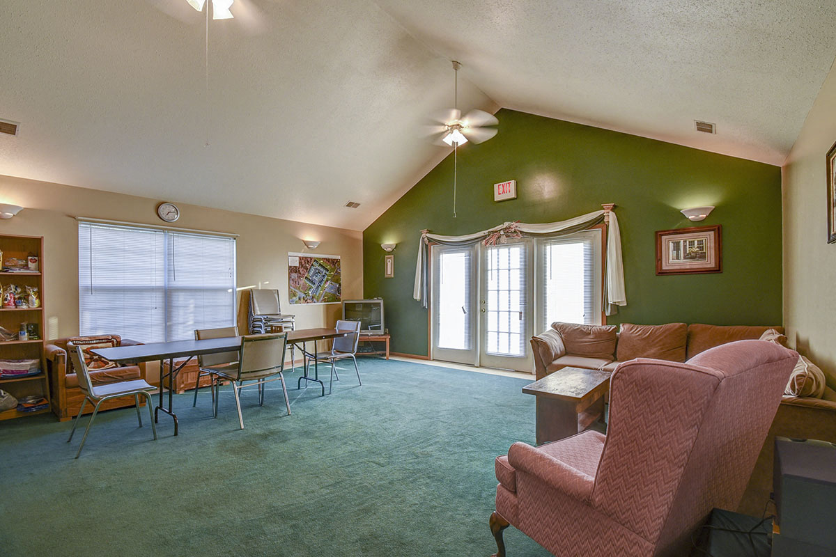 a living room and dining room with a table and chairs