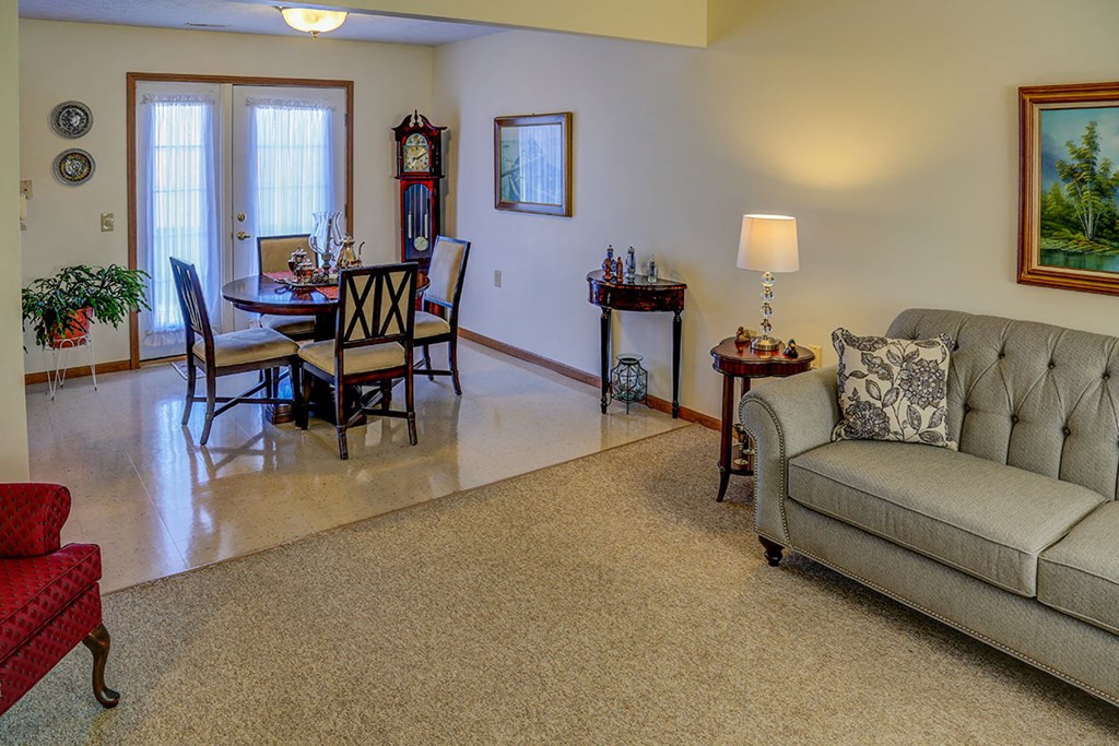 a living room with a couch and a dining room table