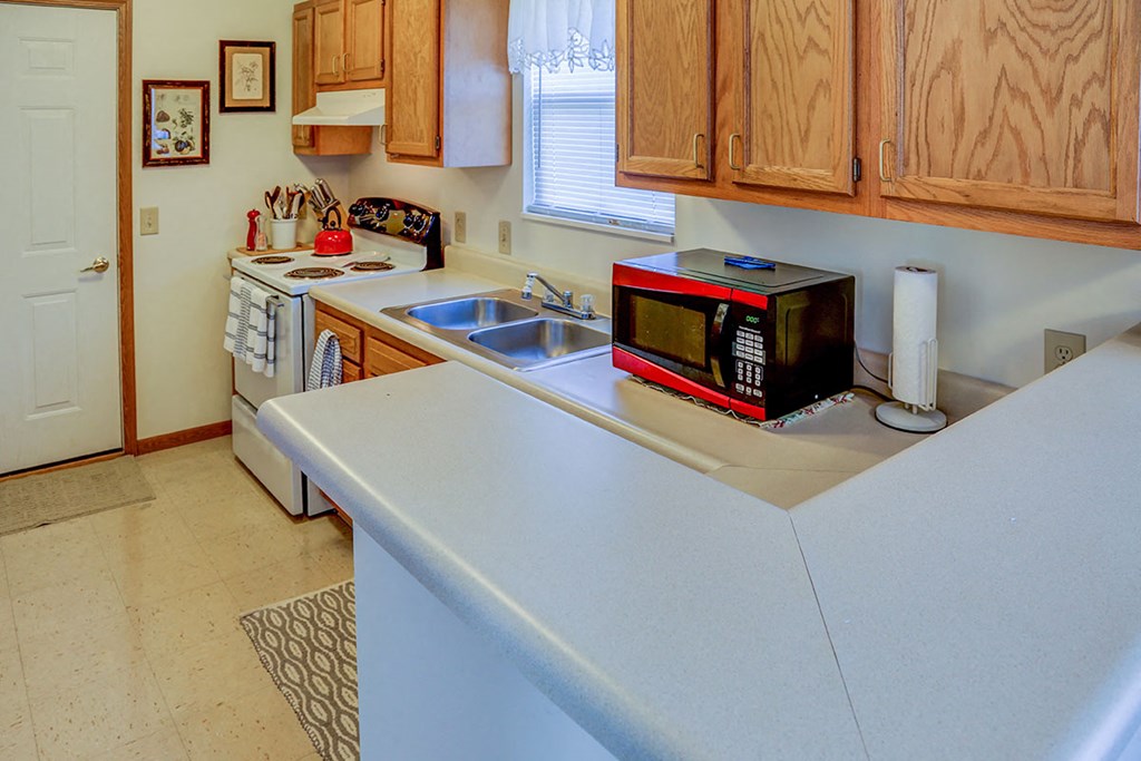 a kitchen with a microwave on the counter