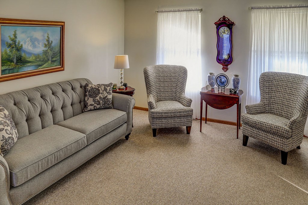 a living room with a couch and two chairs