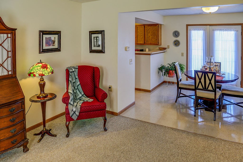 a living room and dining room with a table and chairs