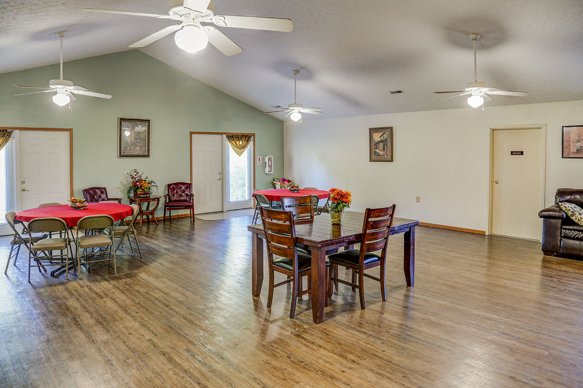 a dining room and living room with a table and chairs