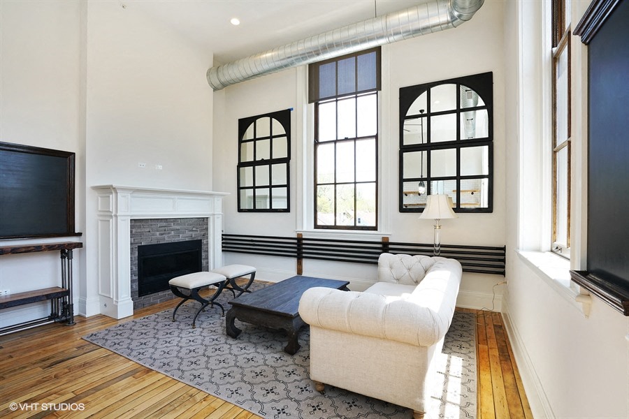 a living room with a couch and a fireplace and a tv