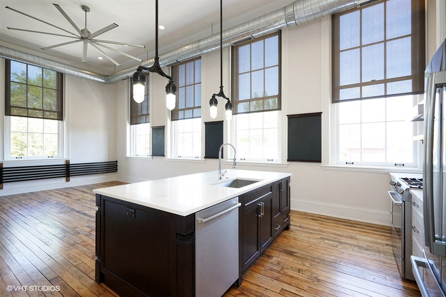 a large kitchen with an island in the middle of it