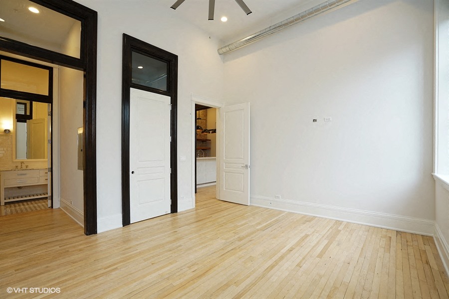 an empty living room with white walls and wood floors