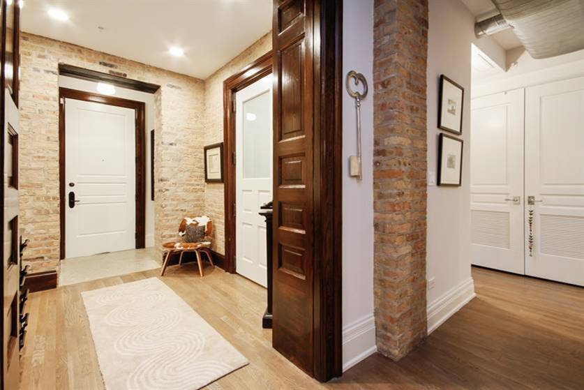 a hallway with two doors and a rug