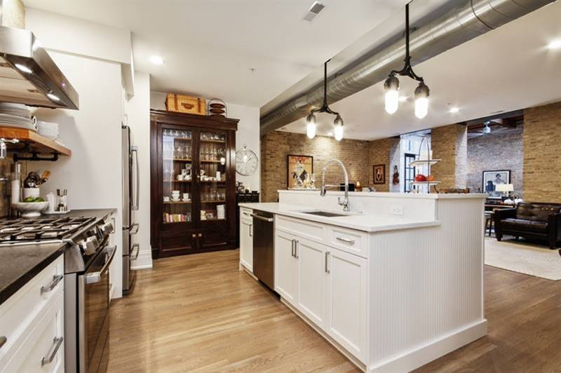a large kitchen with a large white counter top