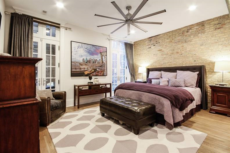 a bedroom with a bed and a ceiling fan