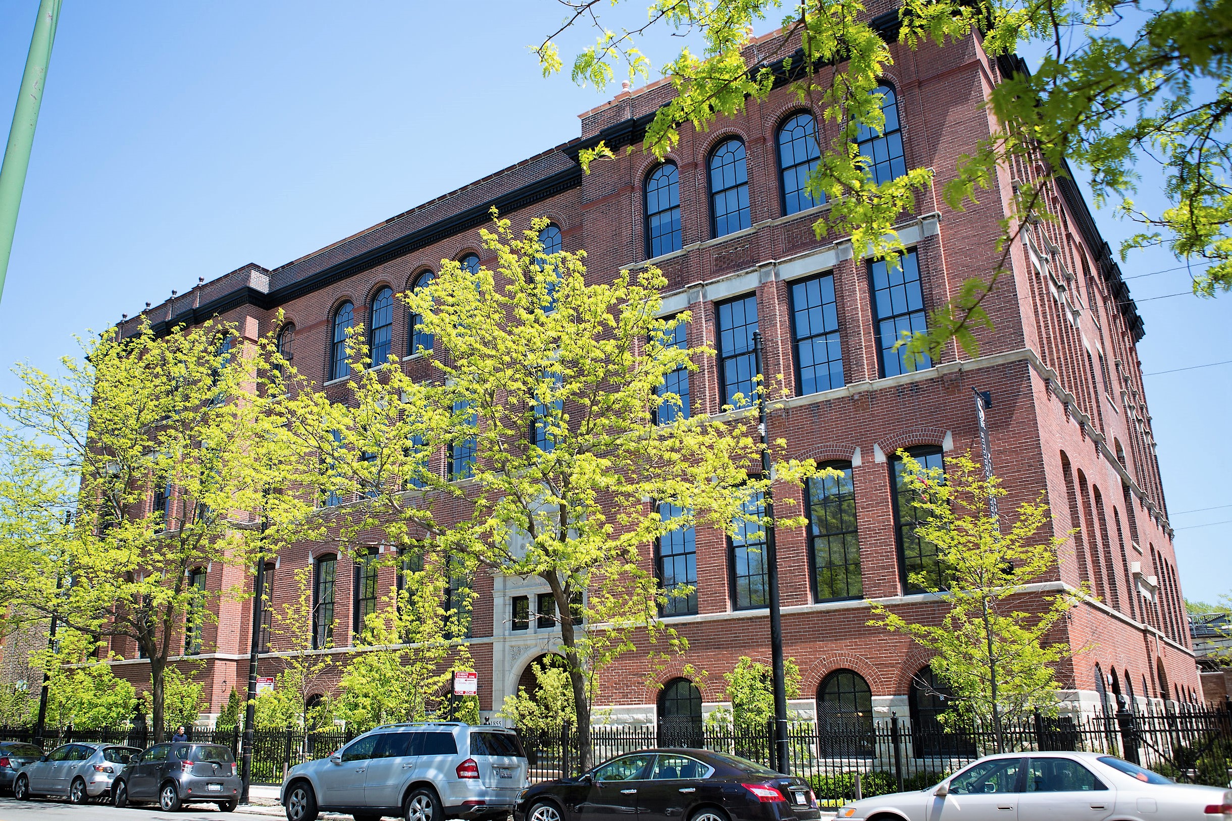 a large brick building with cars parked in front of it
