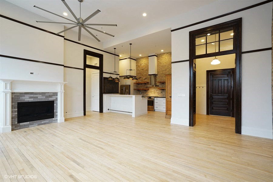 an empty living room with a fireplace and a