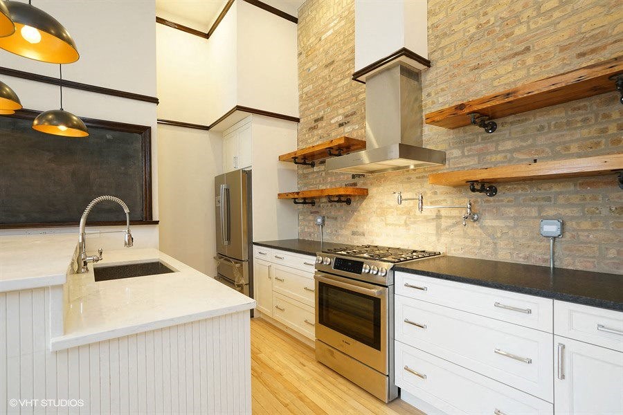 a white kitchen with a stove and a sink