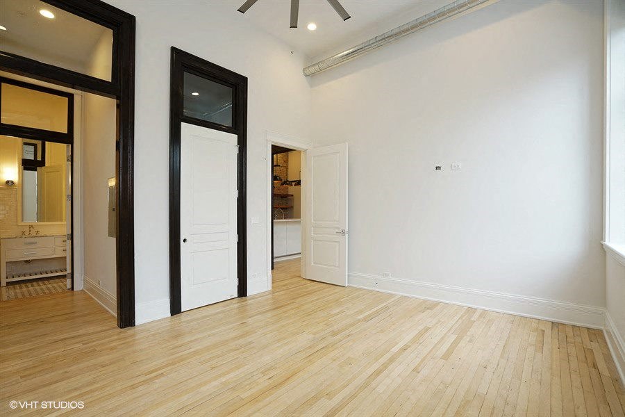 an empty living room with white walls and wooden floors