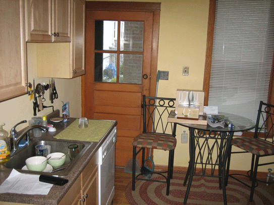 a kitchen with a table and chairs and a sink