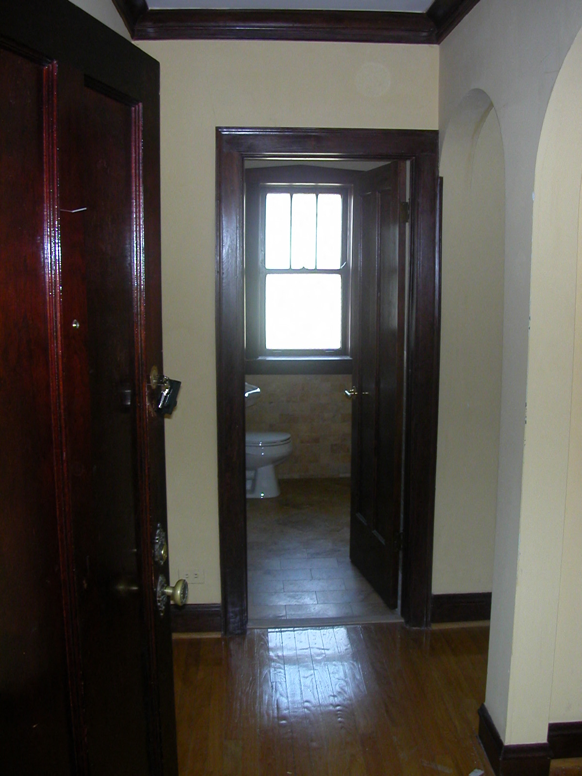 a small bathroom with a toilet and a window