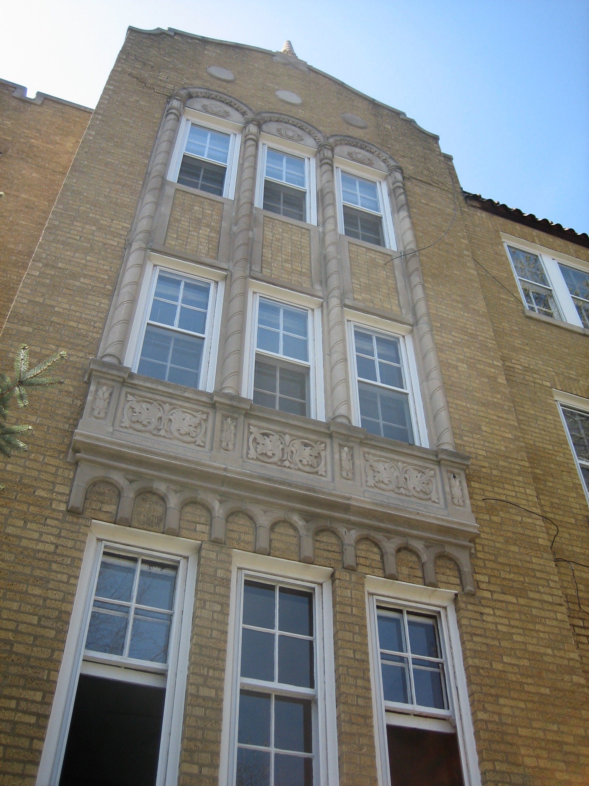 the front of the building has a lot of windows