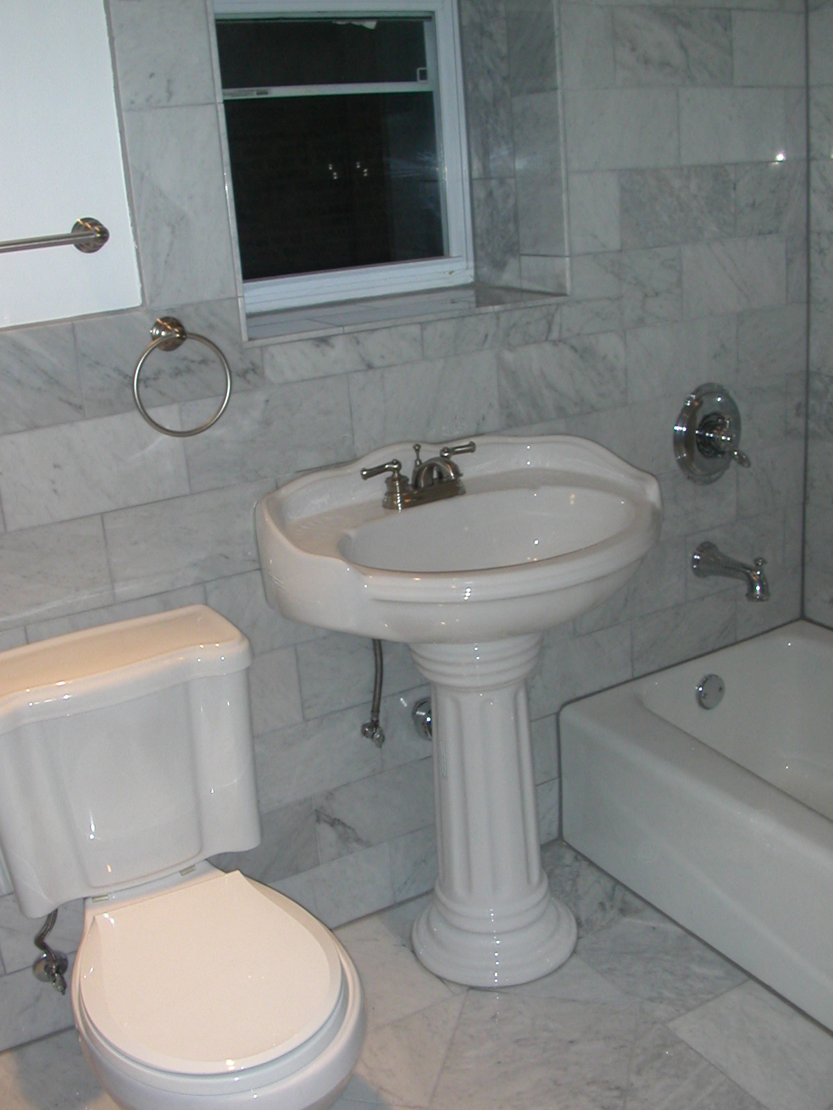 a bathroom with a toilet and a sink and a tub