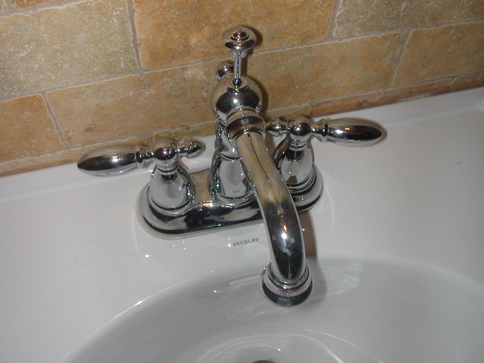 a close up of a sink faucet in a bathroom