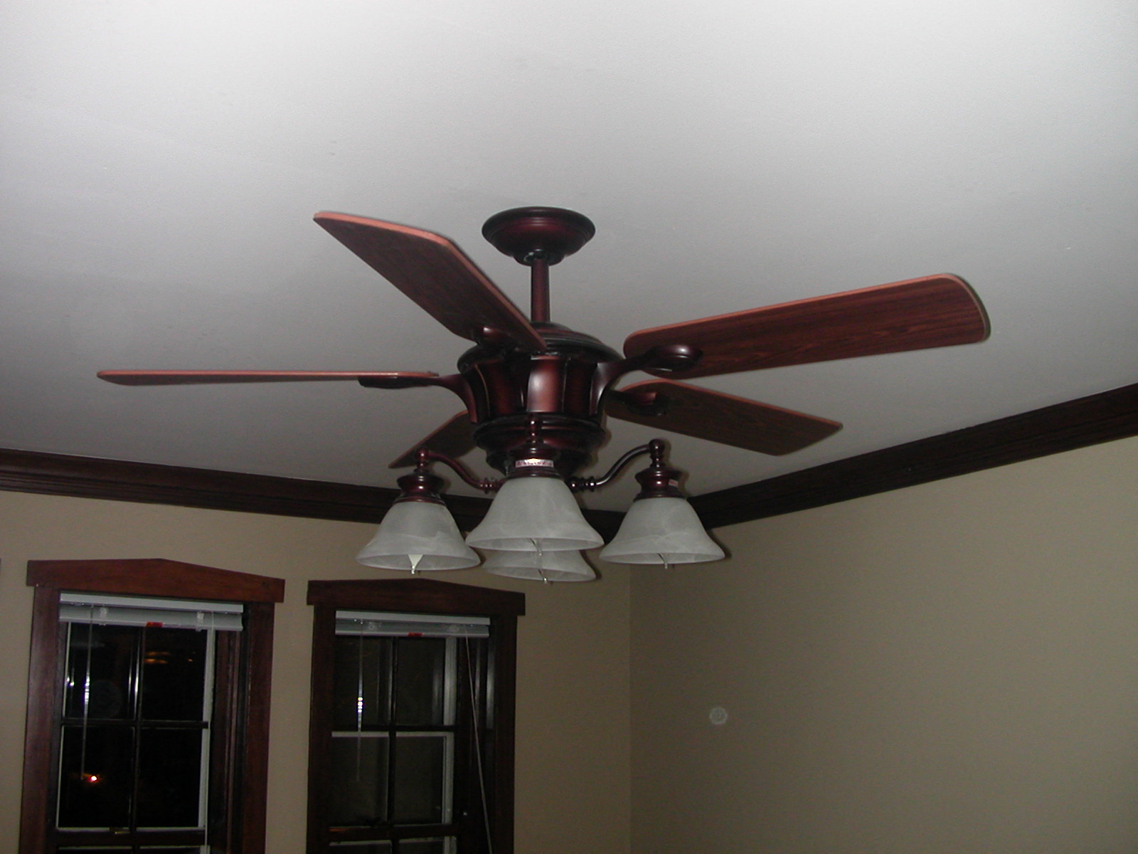a ceiling fan with three lights in a living room