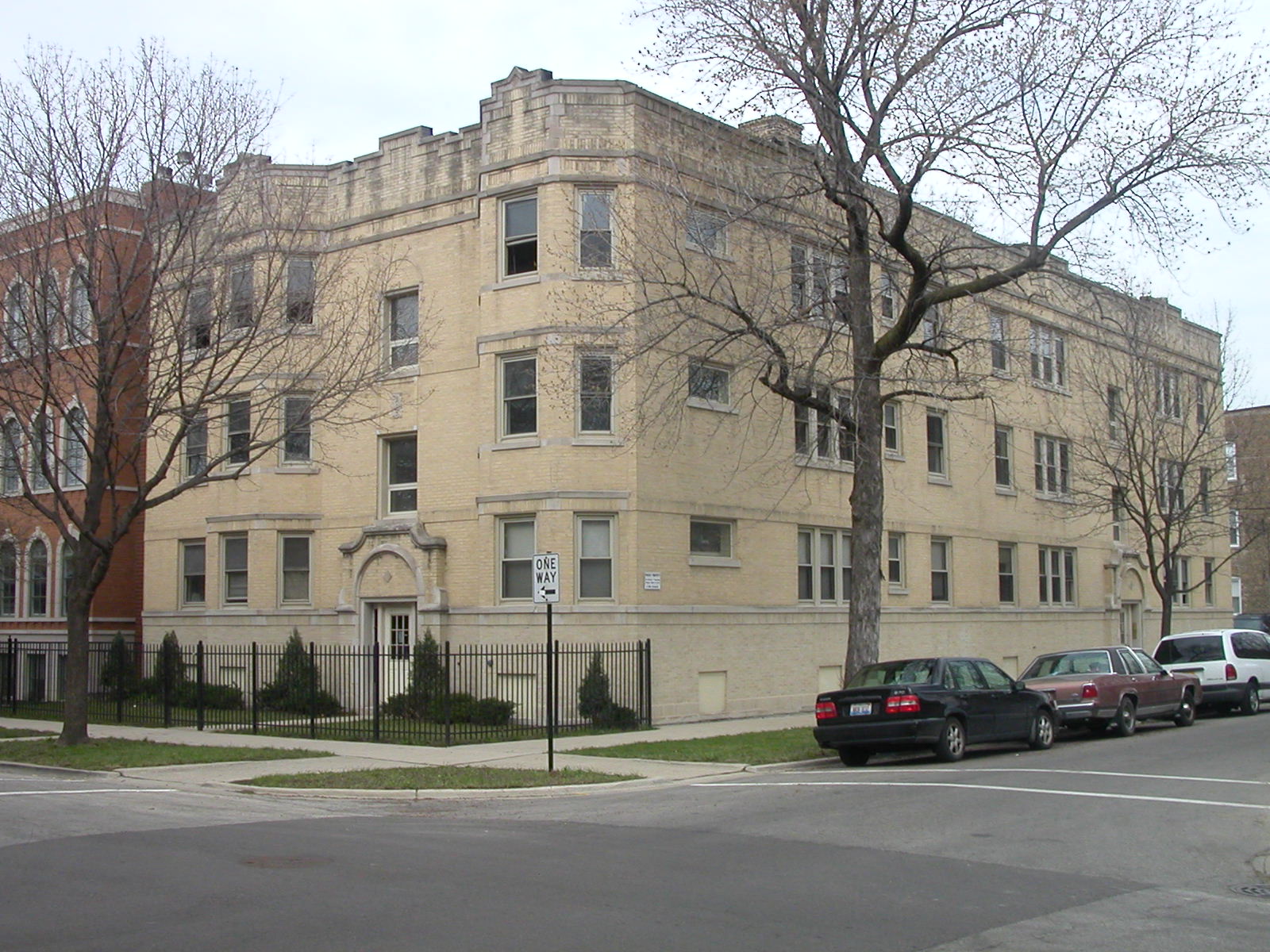 a large building with cars parked in front of it