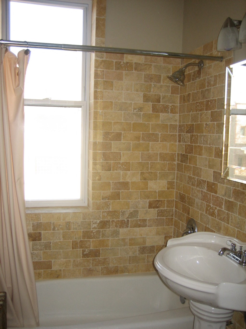 a bathroom with a sink and a tub and a window