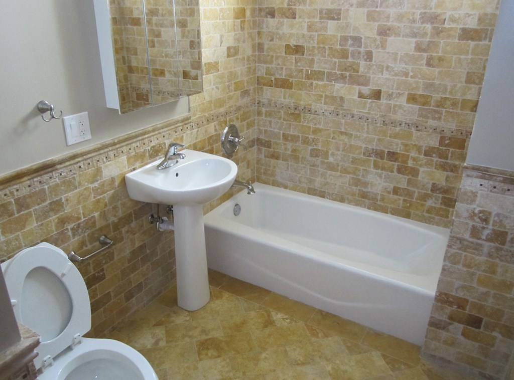 a bathroom with a sink and a tub and a toilet