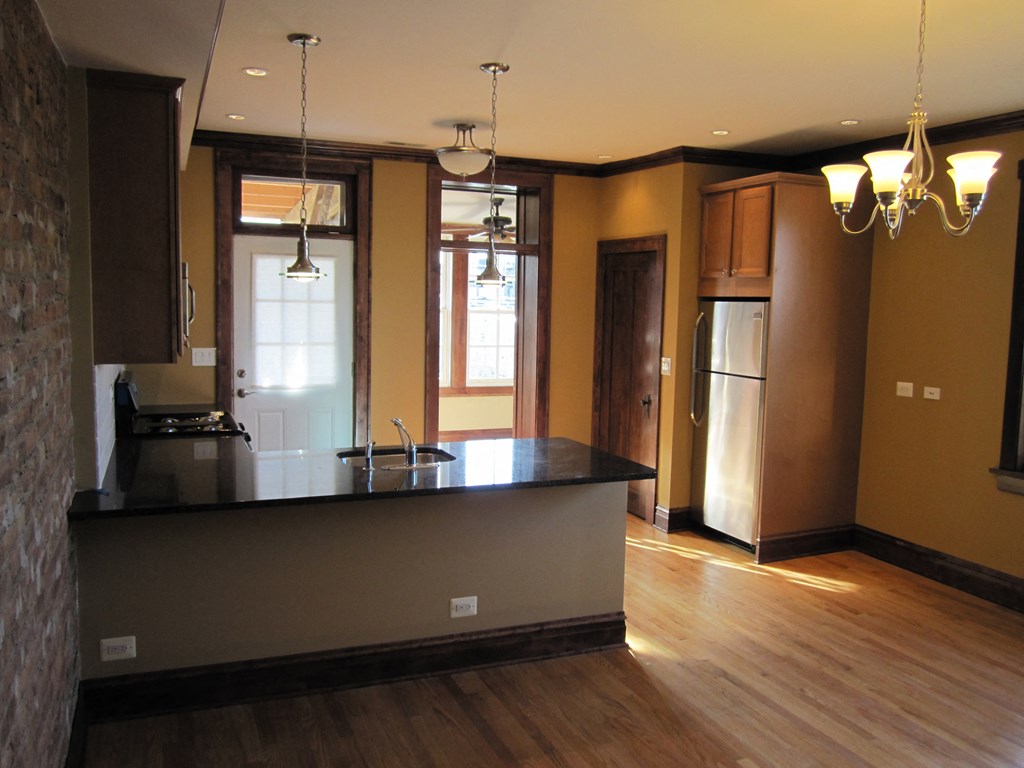an empty kitchen with a large island in the middle of it