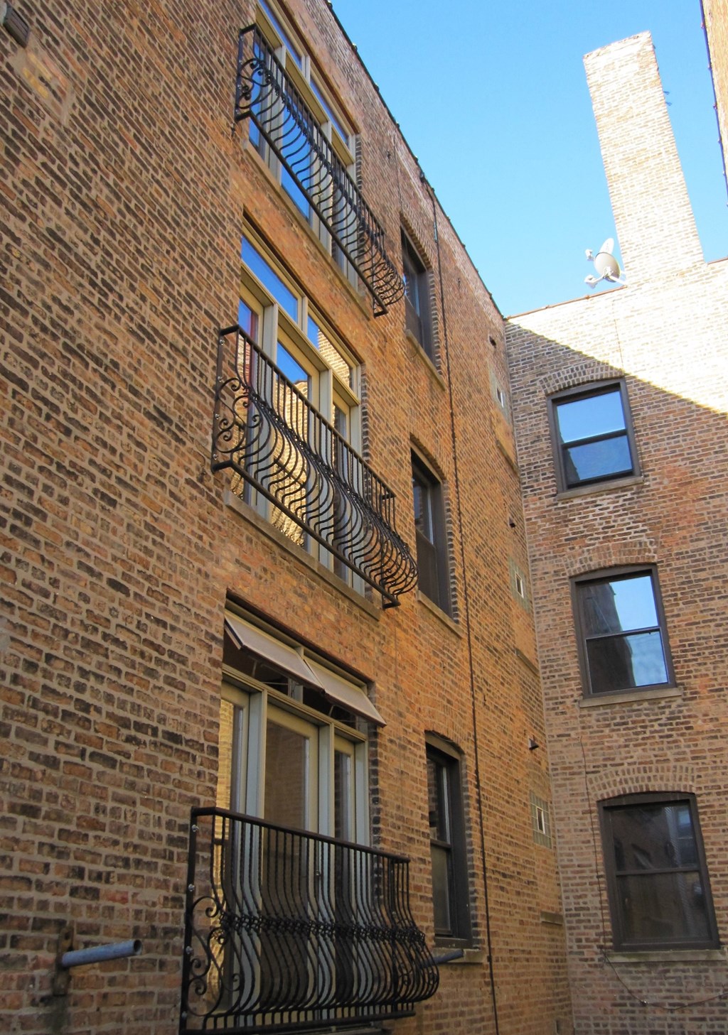 a brick building with two balconies and a window
