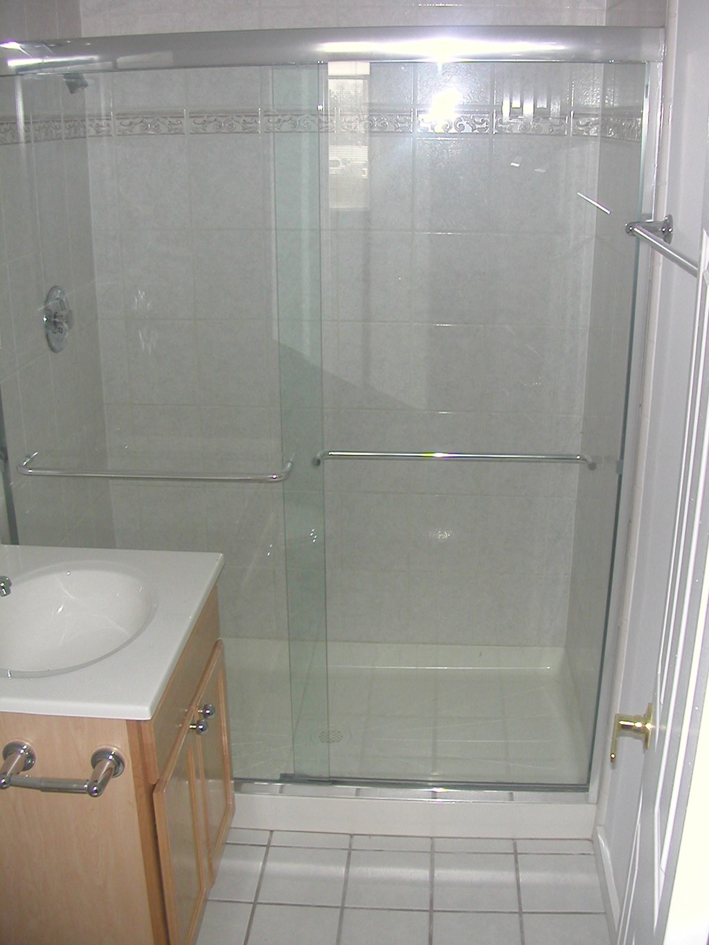 a small bathroom with a shower and a sink