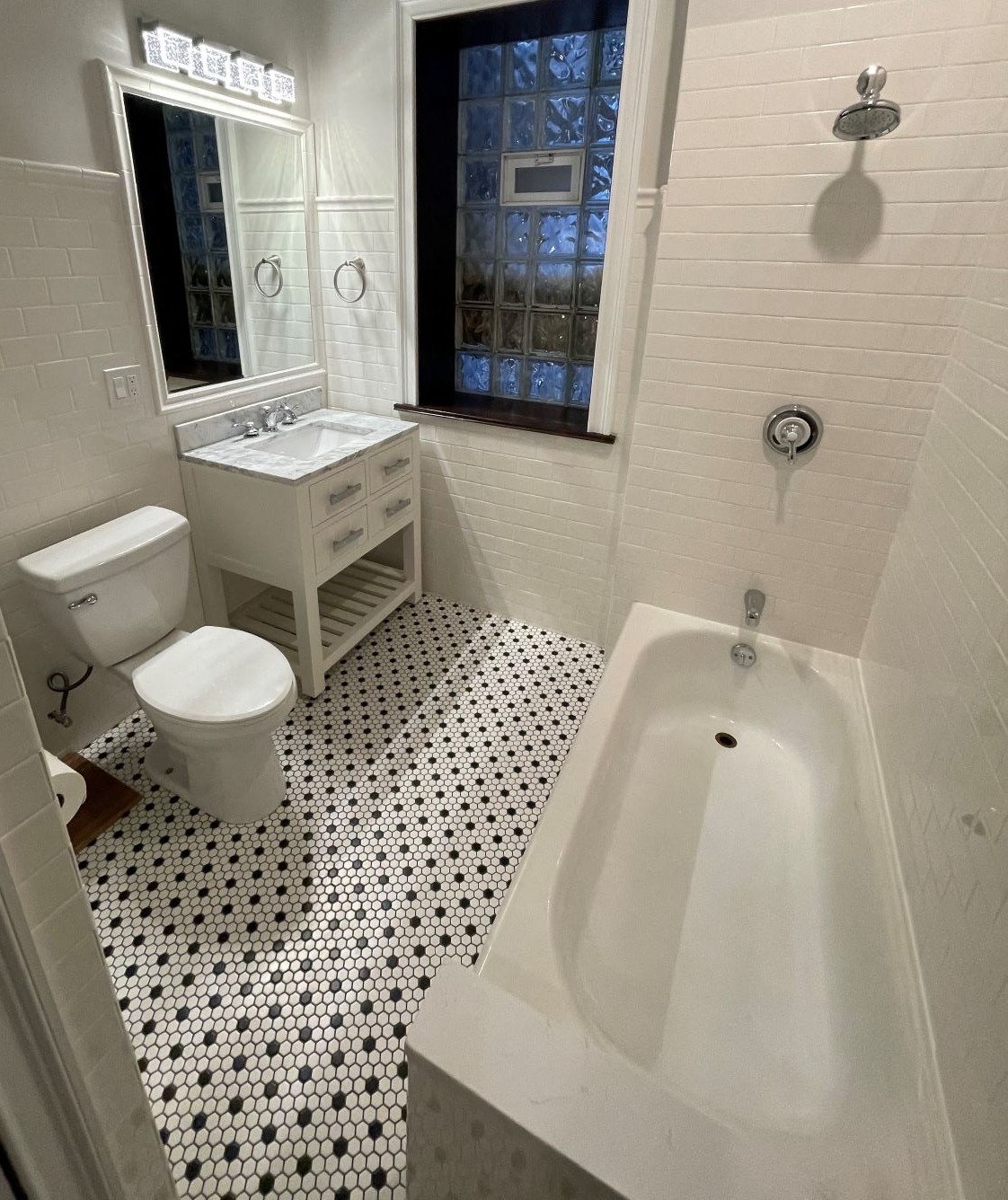 a bathroom with a toilet and a tub and a sink