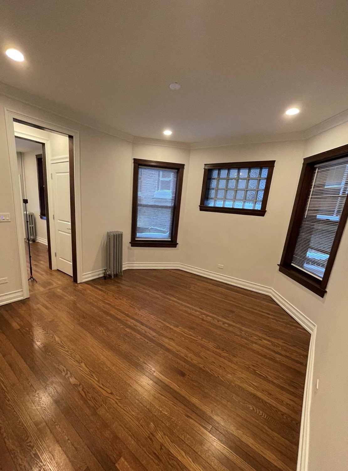 a living room with a hard wood floor and a window