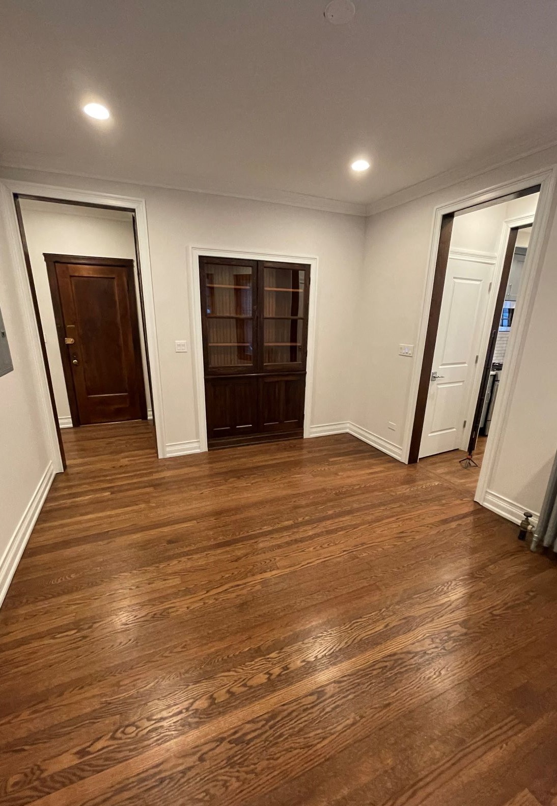 a living room with a hard wood floor and a closet