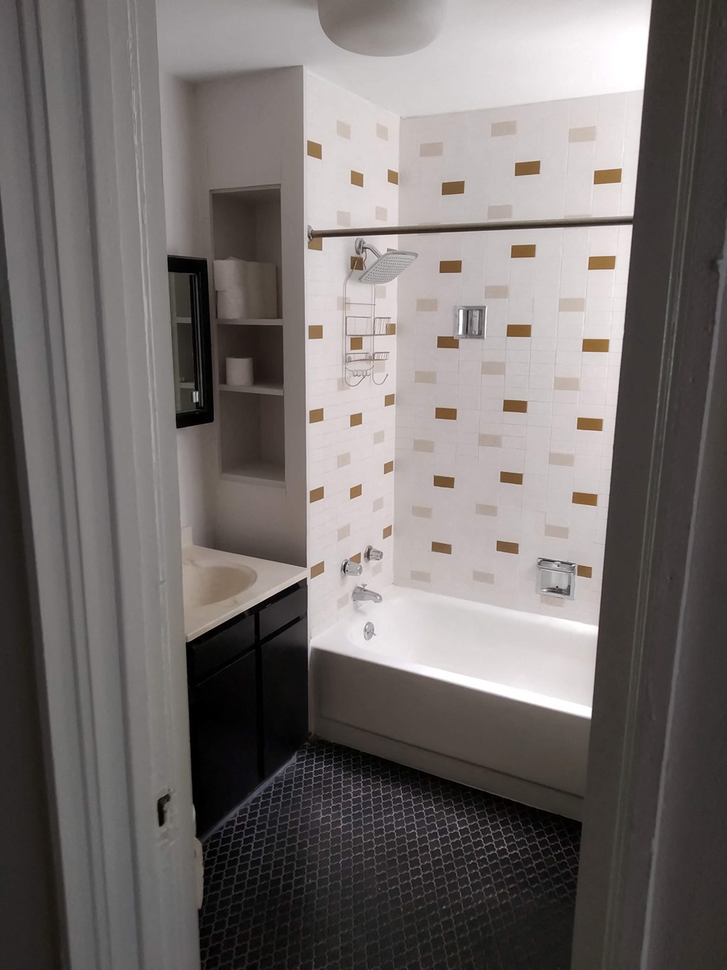 a small bathroom with a tub and a sink