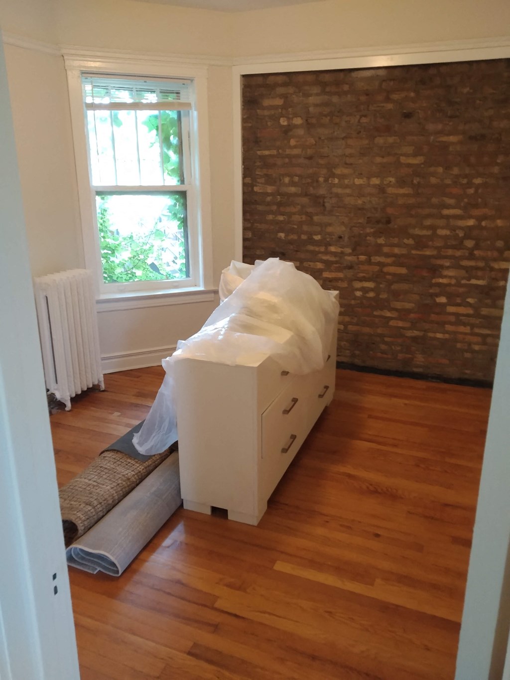 a box sitting on the floor in a room with a window