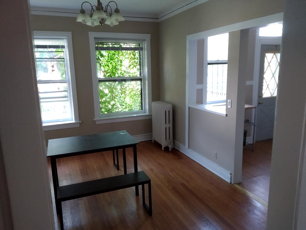 an empty living room with a table and a window