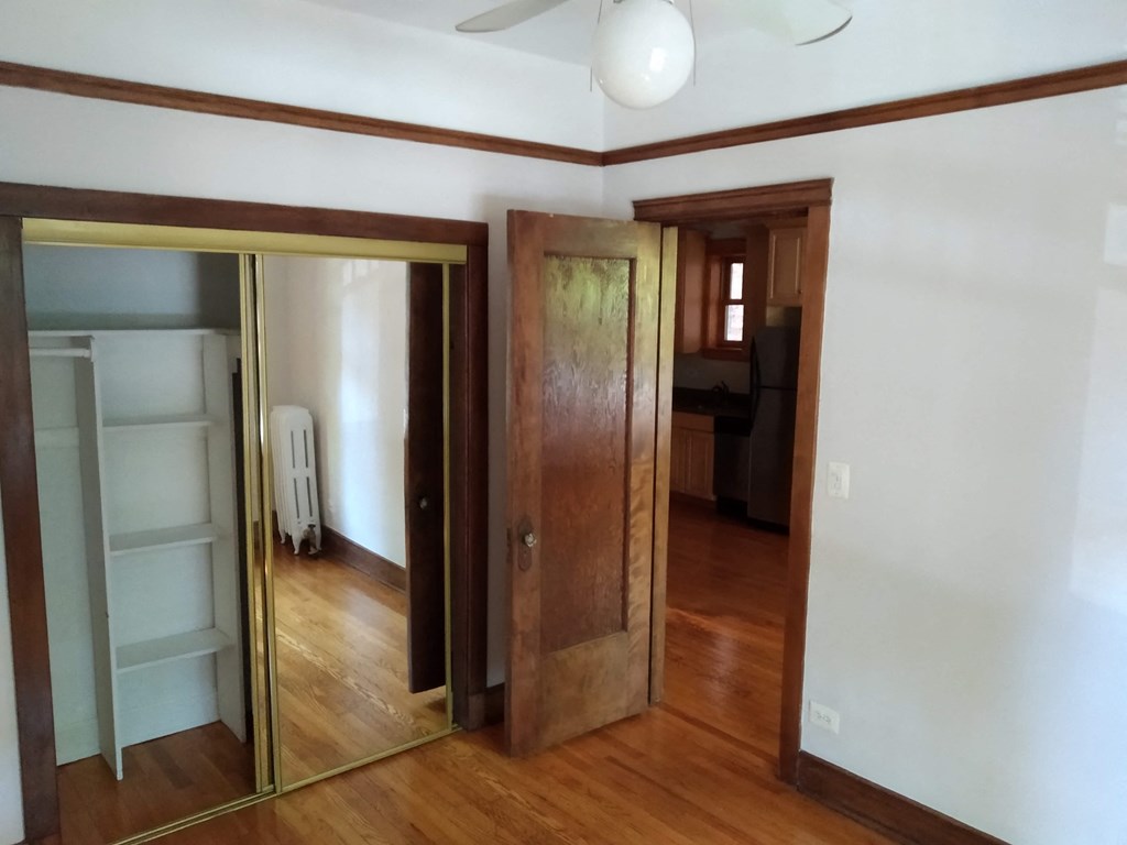 an empty room with a mirror and a closet