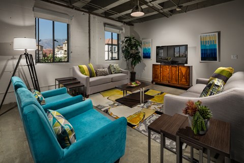 a living room with couches and chairs and a tv