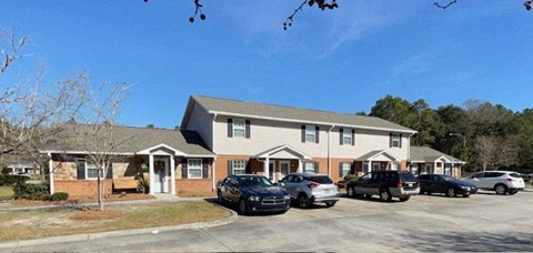 a house with cars parked in a parking lot