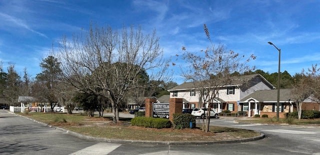 a roundabout in a neighborhood with houses and trees